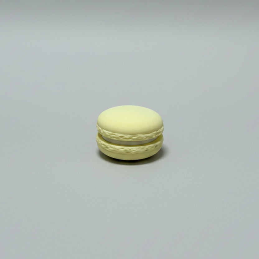 Yellow macaron on a wooden surface