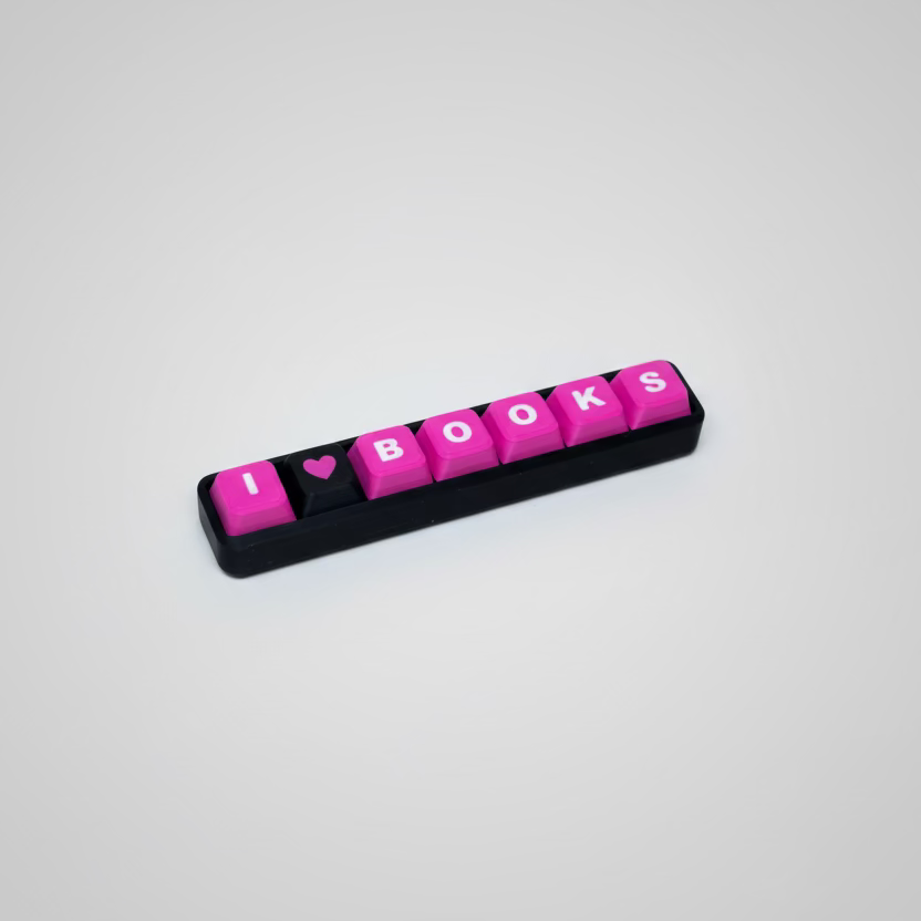 Keychain with 'I ❤️ BOOKS' text on a wooden surface