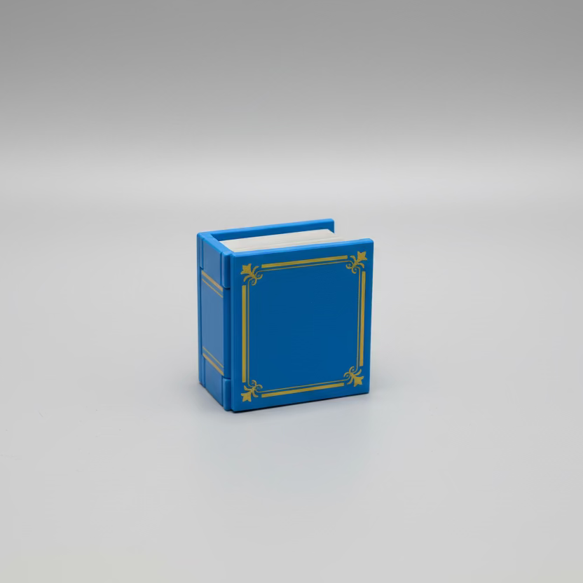 Blue box with gold accents on a grey surface