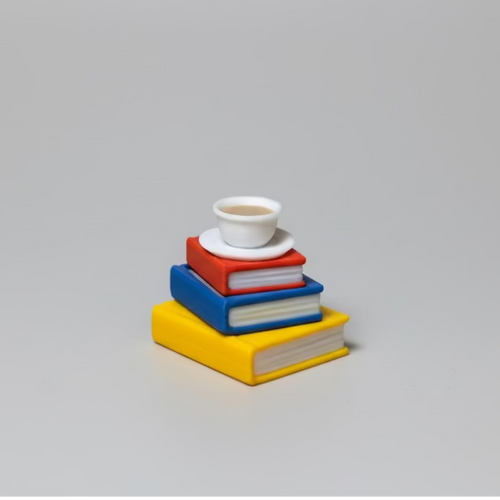 Stack of colorful books with a white cup on a gray background