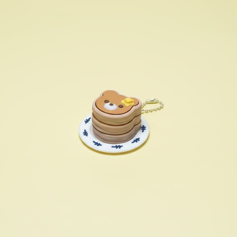Small pancake stack toy with a bear design on a yellow surface