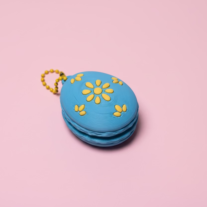 Blue container with yellow floral designs on a wooden surface