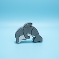 Gray dolphin fidget clicker on a blue background