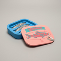 Sardine can-shaped container with sardines on a grey surface
