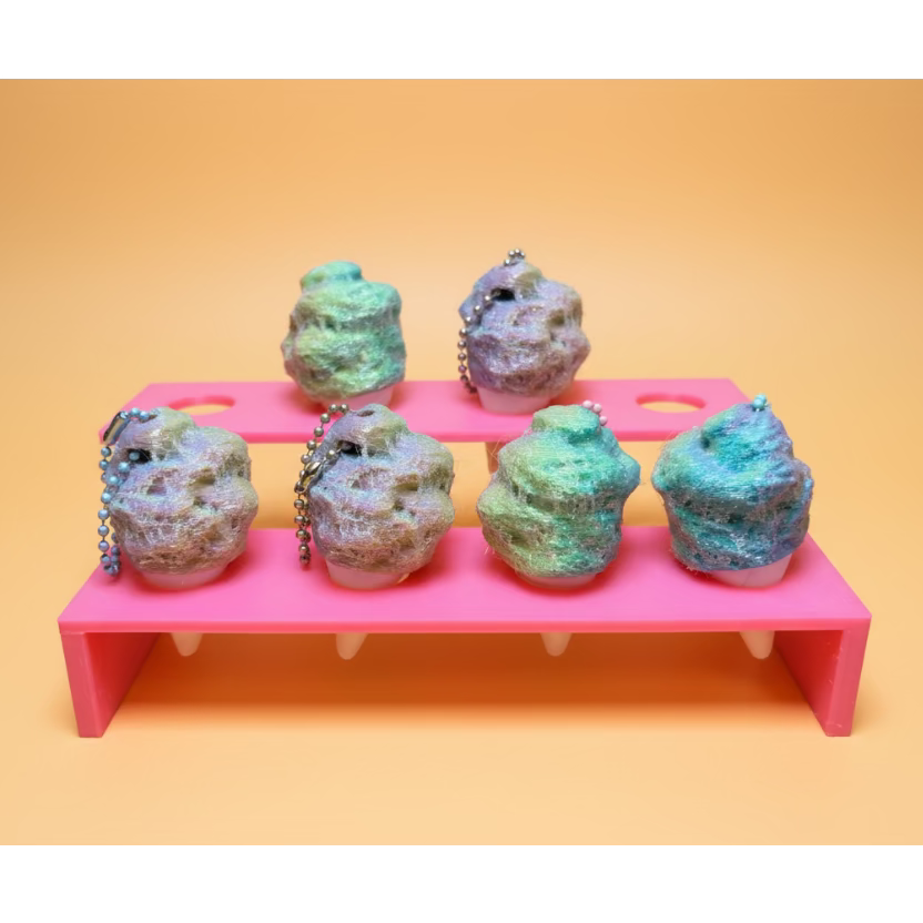 Cotton candy fidget clickers in a pink holder