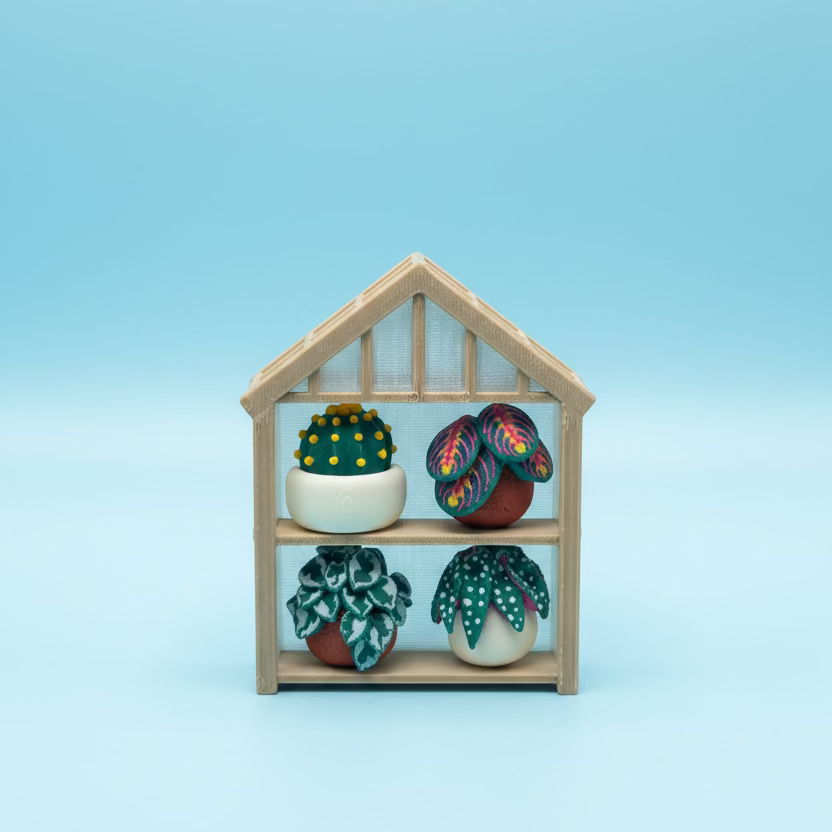 Small wooden house-shaped display case with colorful items on a wooden surface.